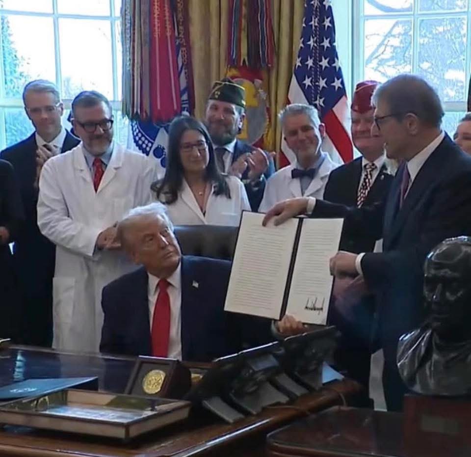 Oval Office signing ceremony for the executive order directing the rescheduling of cannabis, with veterans, service organization representatives and physicians gathered around the Resolute Desk.